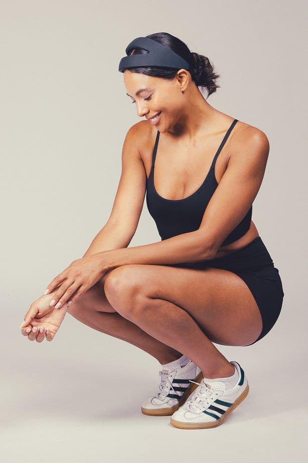 Woman crouching wearing a Samphire device